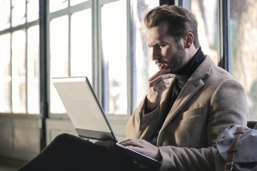 men looking surprized at the laptop