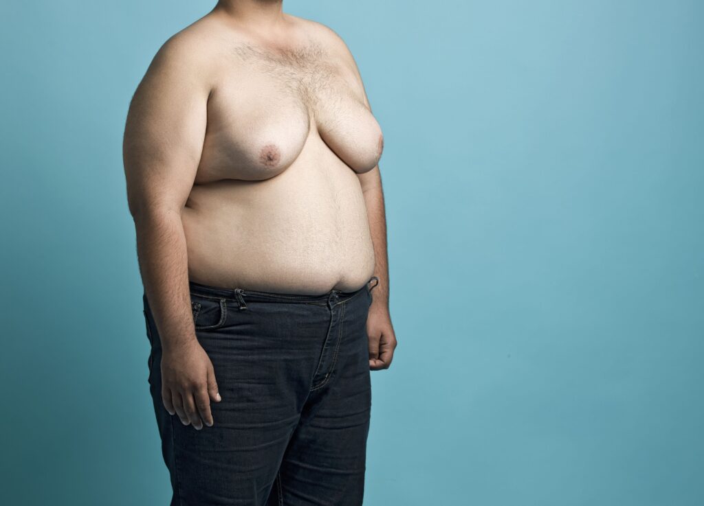 fat man that is trying to get rid of man boobs